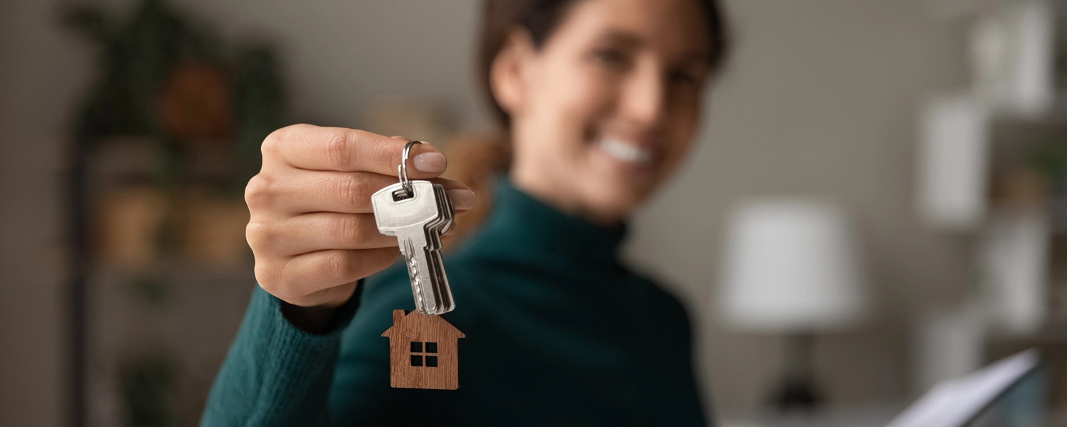 An image of a woman holding house keys